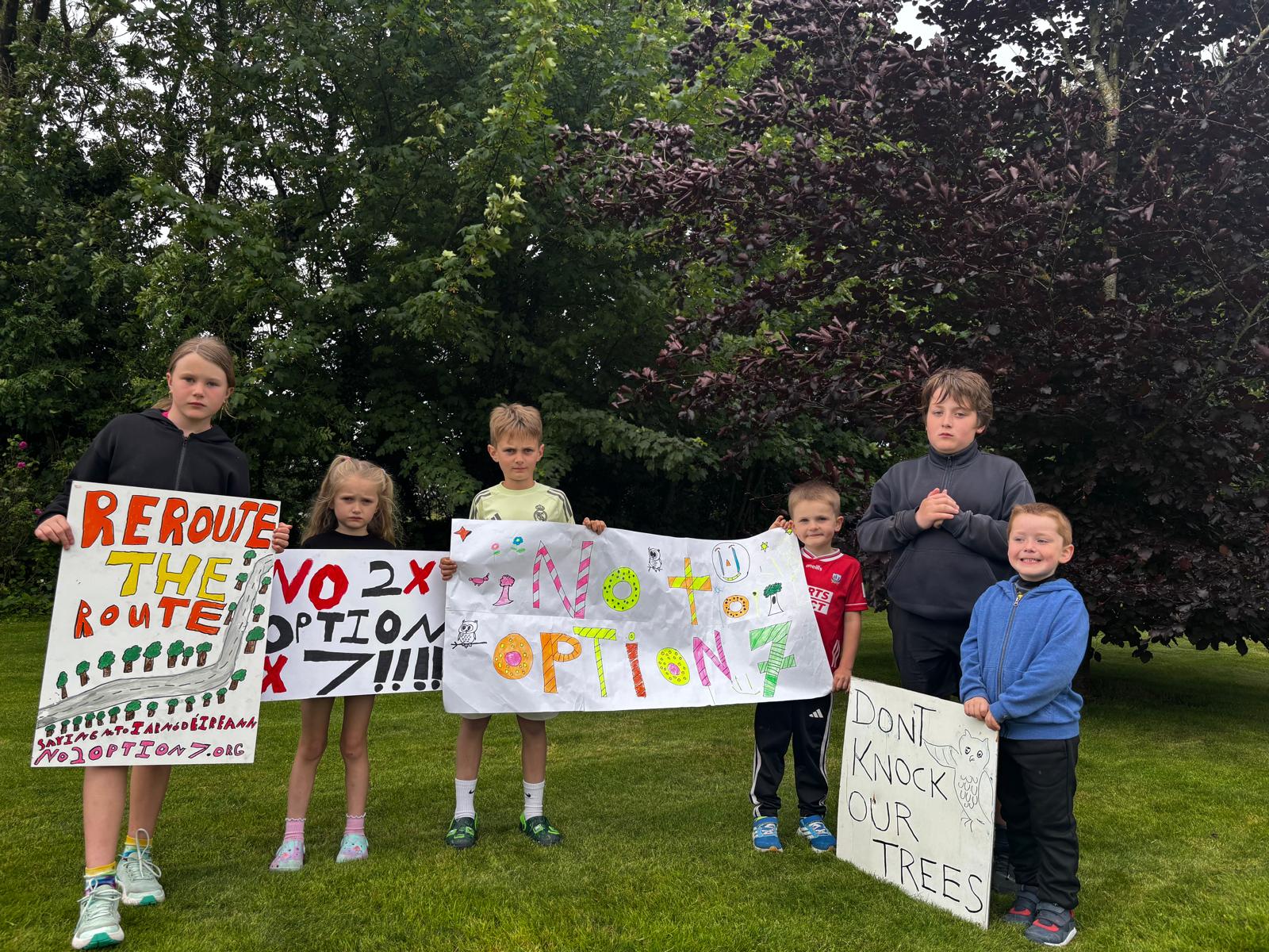 Children holding handmade protest signs